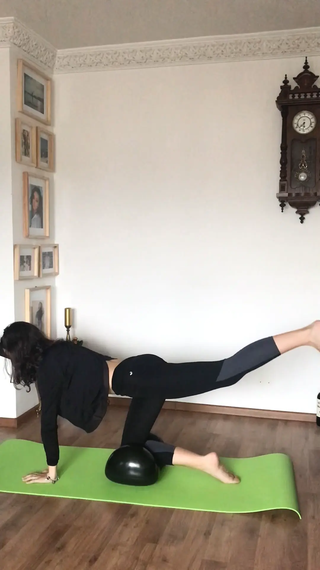 Black haired girl doing leg workout on an Air8 Cushion on a fitness mat in her living room