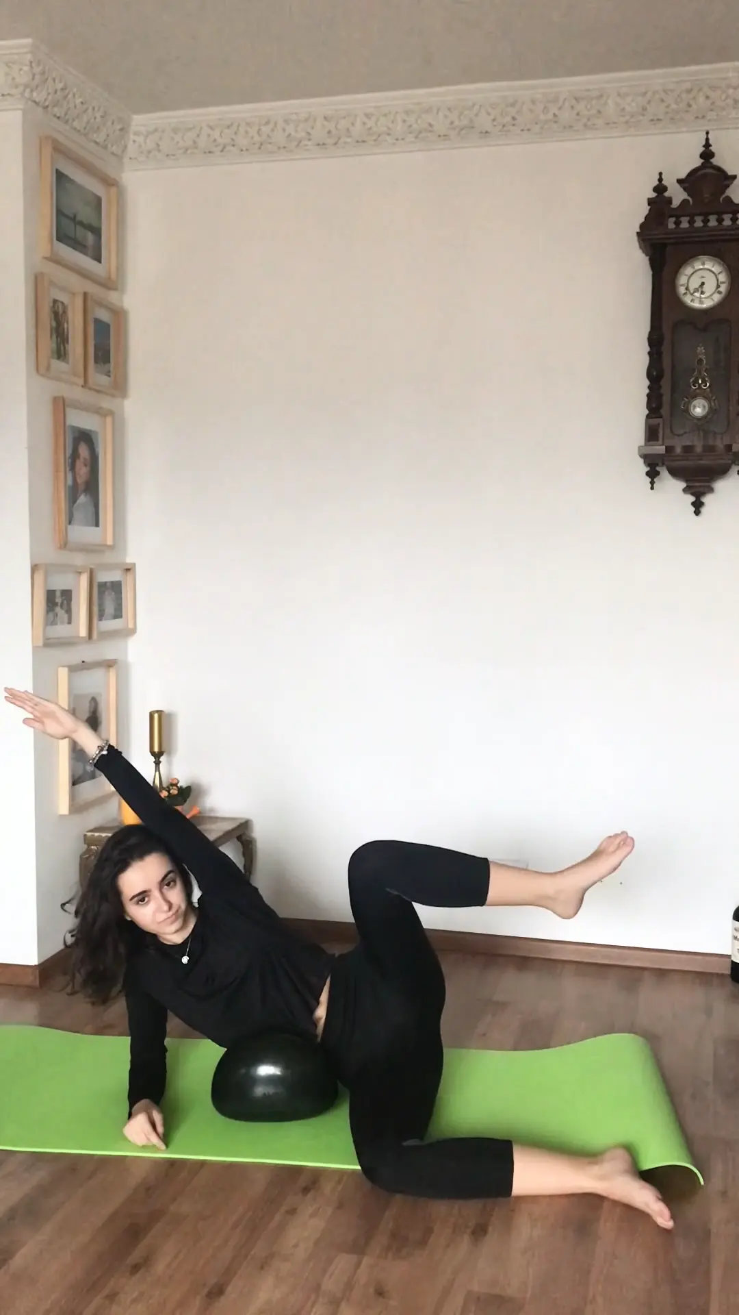 Woman doing fitness on black Air8 Cushion at home on a fitness mat