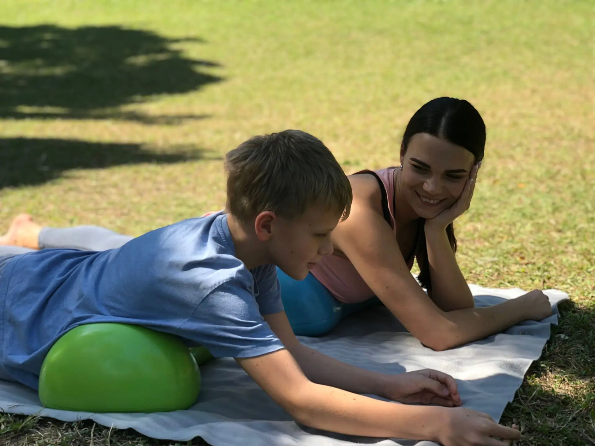 Mother and son lying on Air8 Cushion and talking in the park