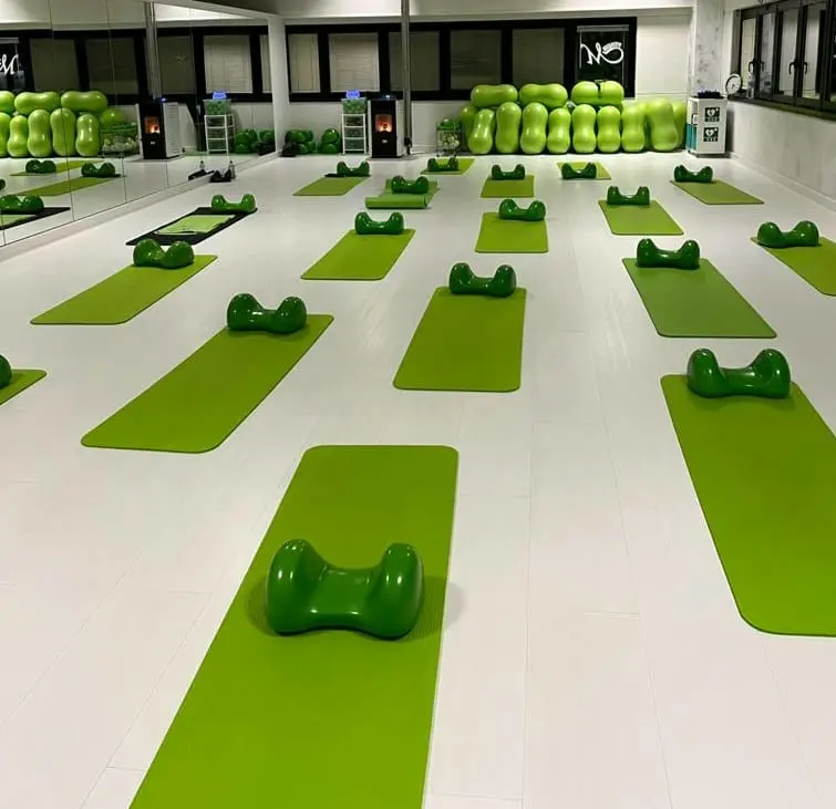 A fitness studio full of green Air8 Cushions on green fitness mats