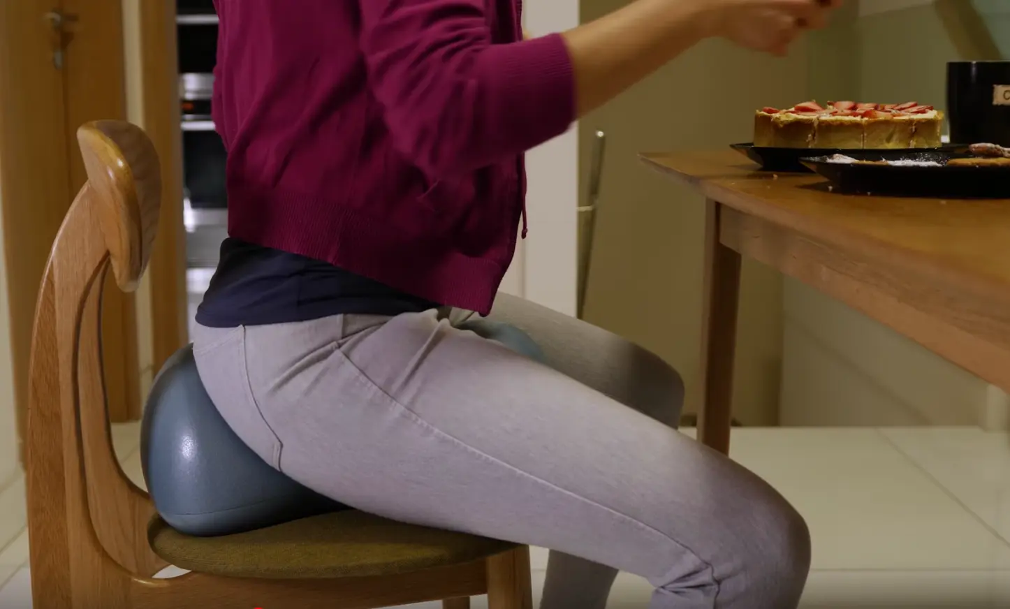 Lady sitting on Air8 Cushion having dinner at home